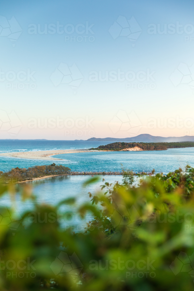 Ocean view with sandbar and foreground greenery - Australian Stock Image