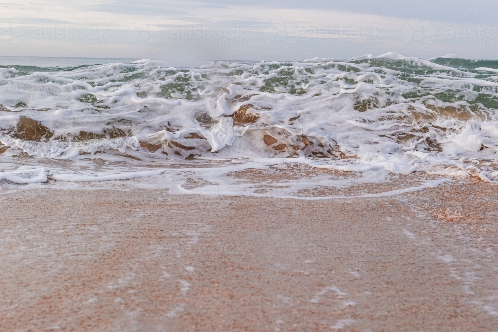 Ocean wave breaking onto shore - Australian Stock Image