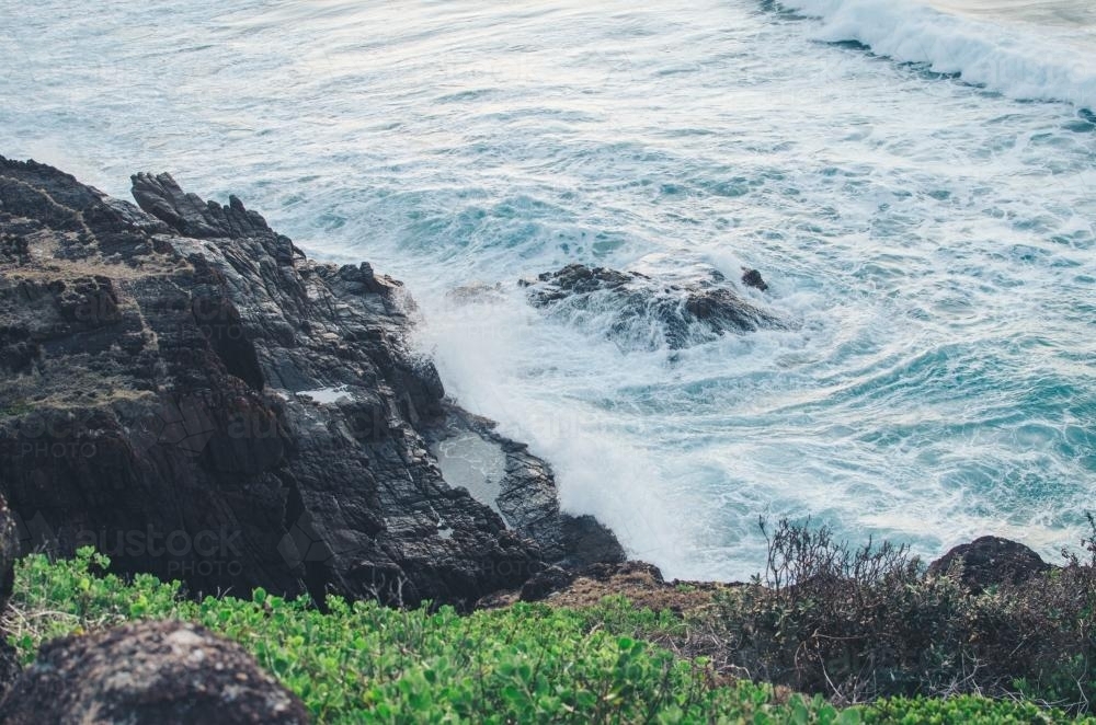 Ocean waves hitting against cliff - Australian Stock Image