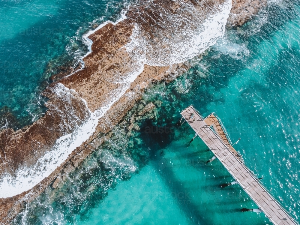 Ocean with jetty and reef from above - Australian Stock Image