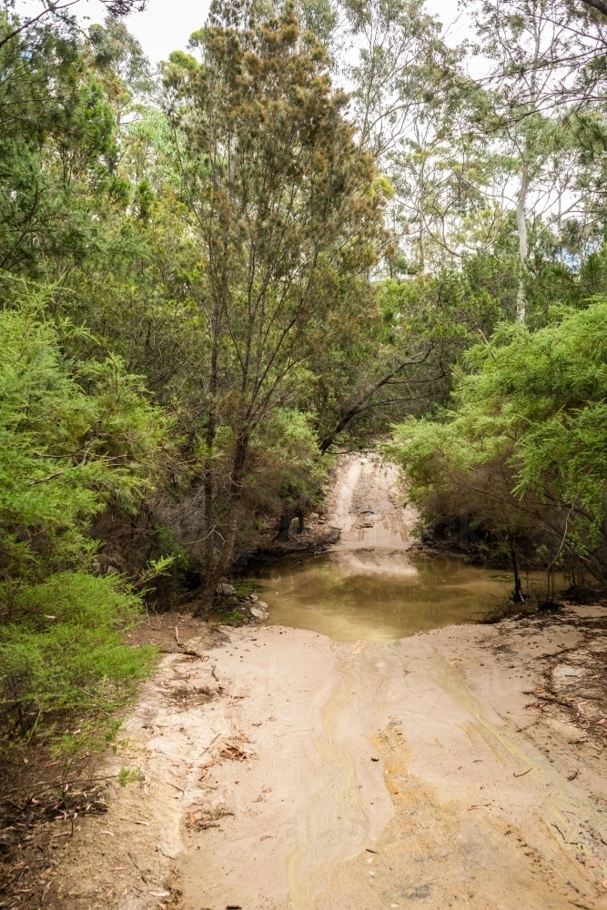off road, dirt track with small water crossing in tasmania - Australian Stock Image