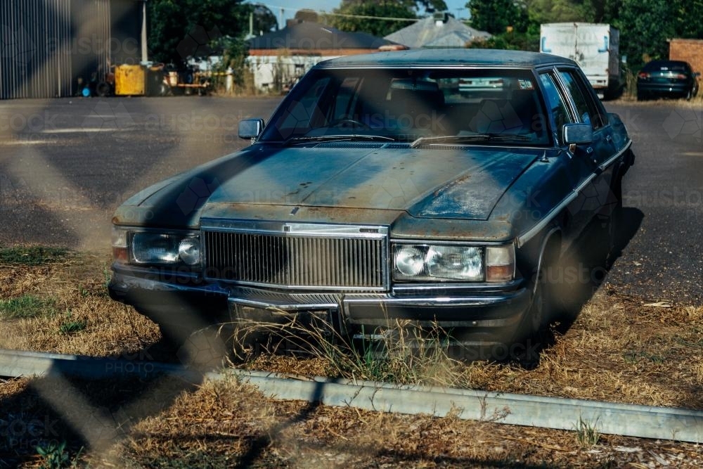 Old abandoned car on a deserted street - Australian Stock Image