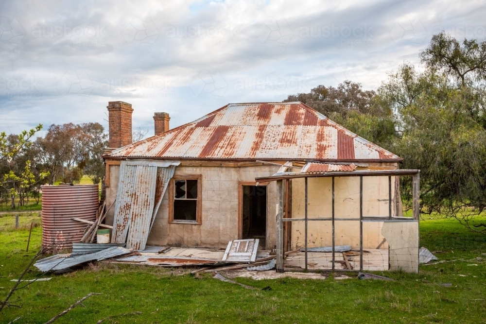 Old abandoned farm house neglected and falling into ruin as time passes - Australian Stock Image