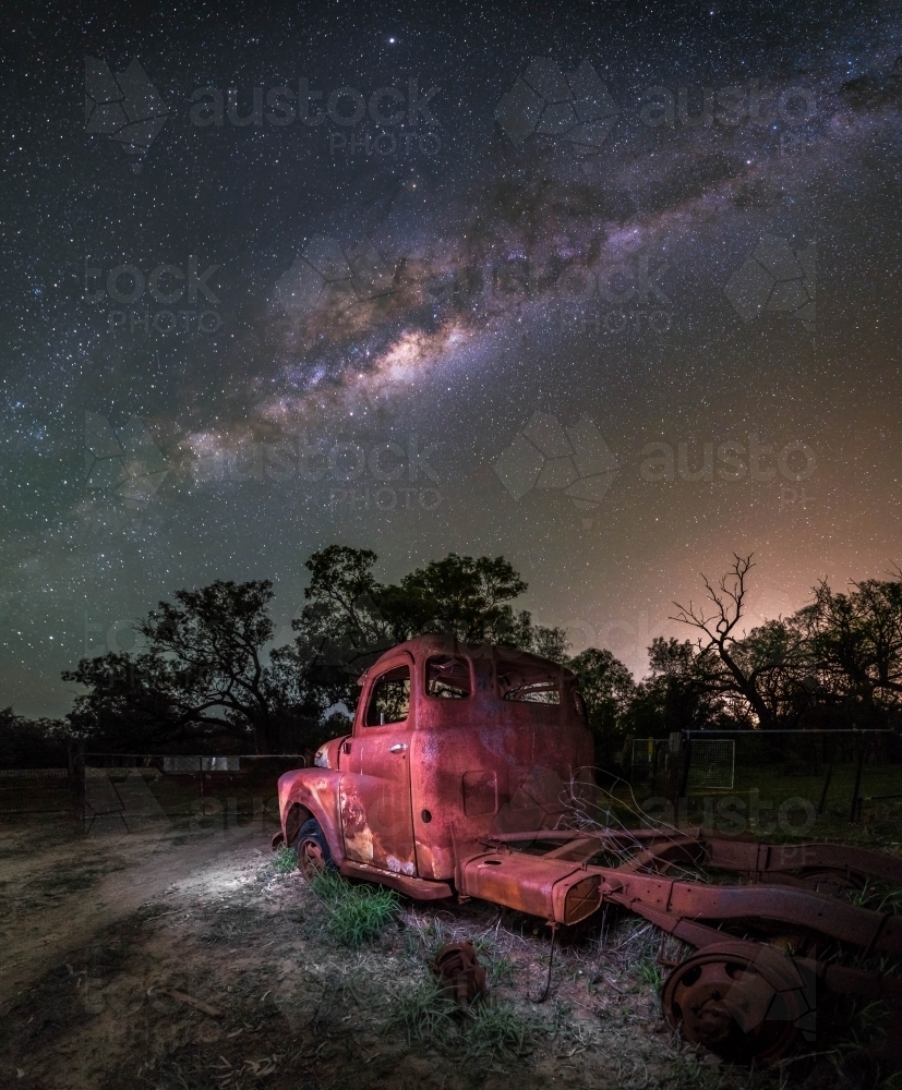 Old abandoned truck in the middle of a field at night - Australian Stock Image