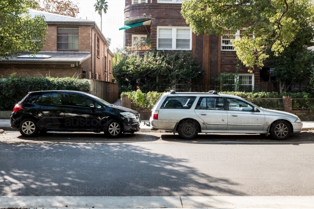 old and new car parked in a suburban street - Australian Stock Image