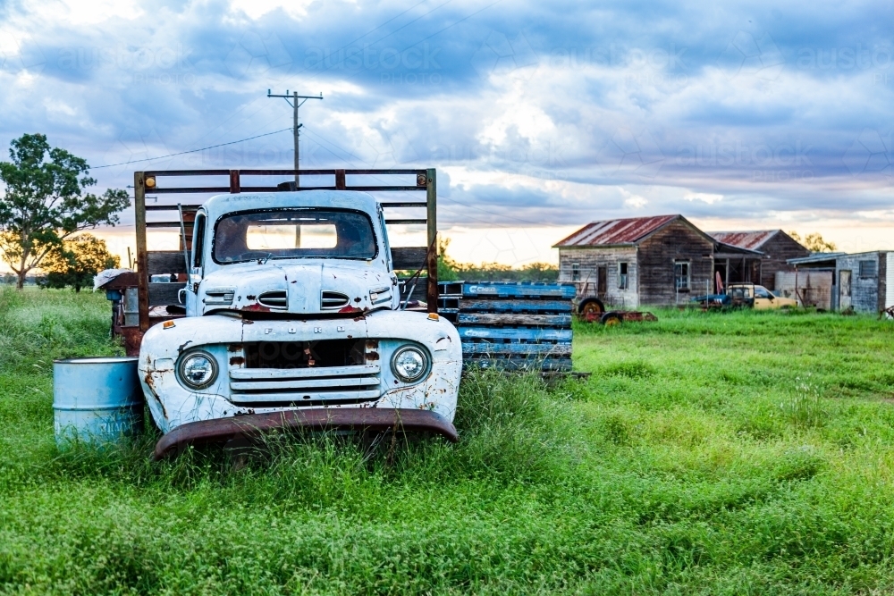 old blue truck in green farm paddock - Australian Stock Image