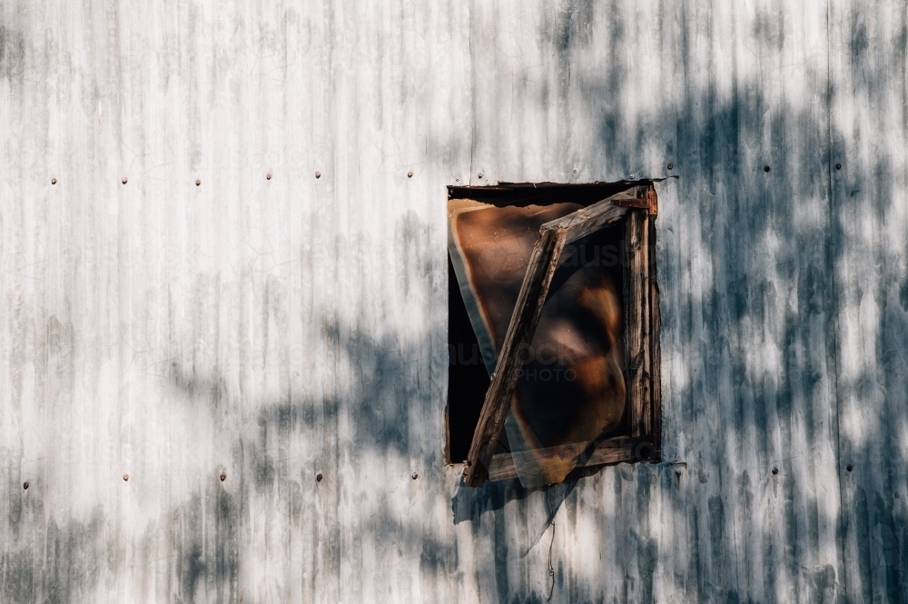 Old broken window in the side of a shed - Australian Stock Image