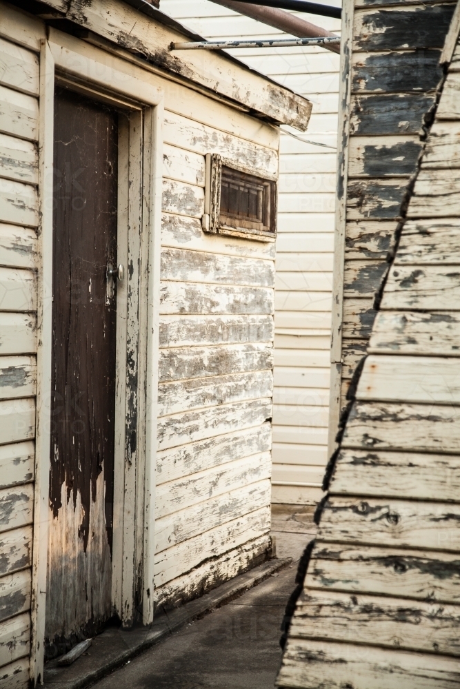 Old buildings on a farm with peeling paint close up - Australian Stock Image