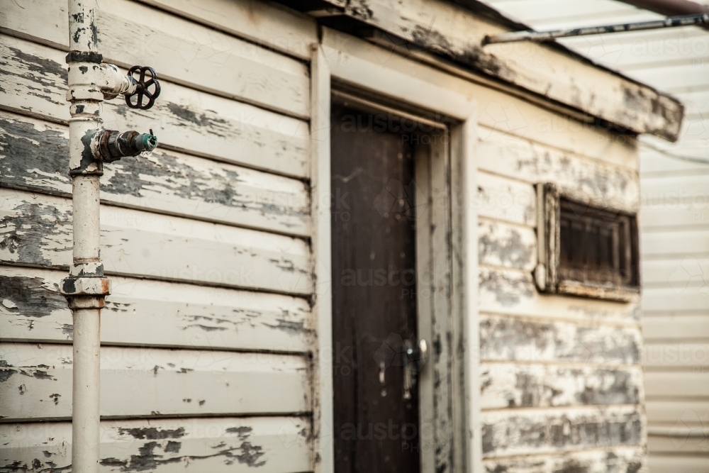 Old buildings on a farm with peeling paint close up - Australian Stock Image