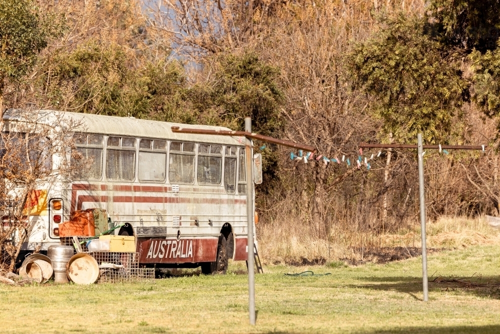 Old bus with Australia written on the side in rural backyard - Australian Stock Image