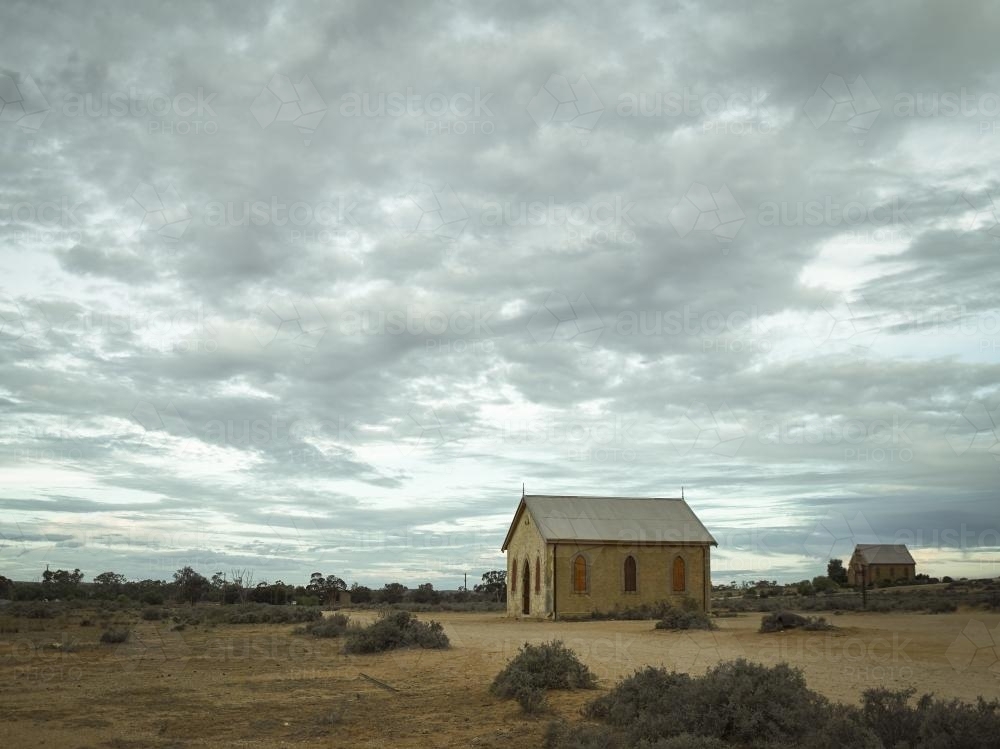 Old church and building in outback against a dramatic sky - Australian Stock Image