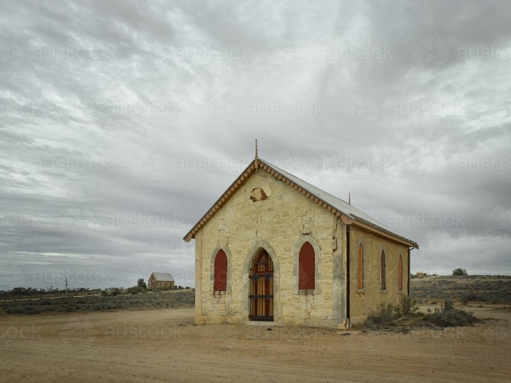 Old church and buildings in outback against a dramatic sky - Australian Stock Image