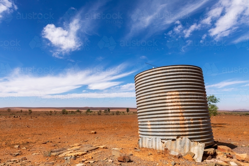 old corrugated iron tank in barren landscape - Australian Stock Image