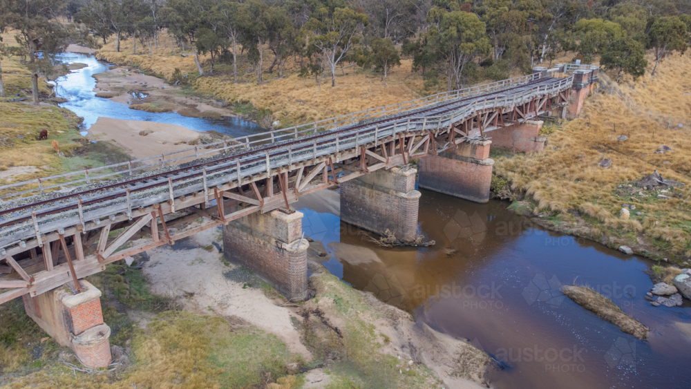 Old country railway bridge over a creek - Australian Stock Image
