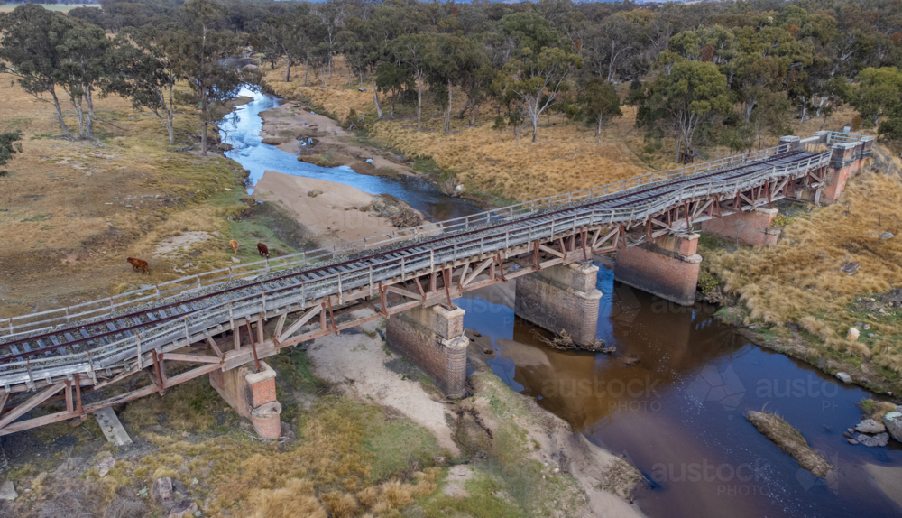 Old country railway bridge over a creek - Australian Stock Image