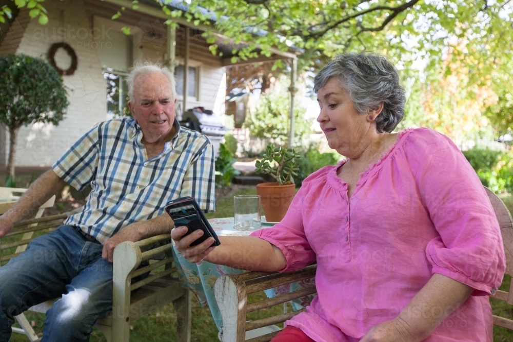 Old couple spending time at their backyard. - Australian Stock Image