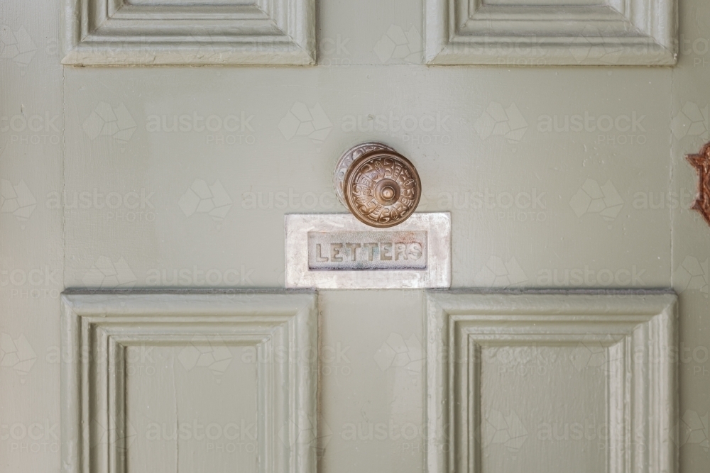 Old door with doorknob and letter slot - Australian Stock Image