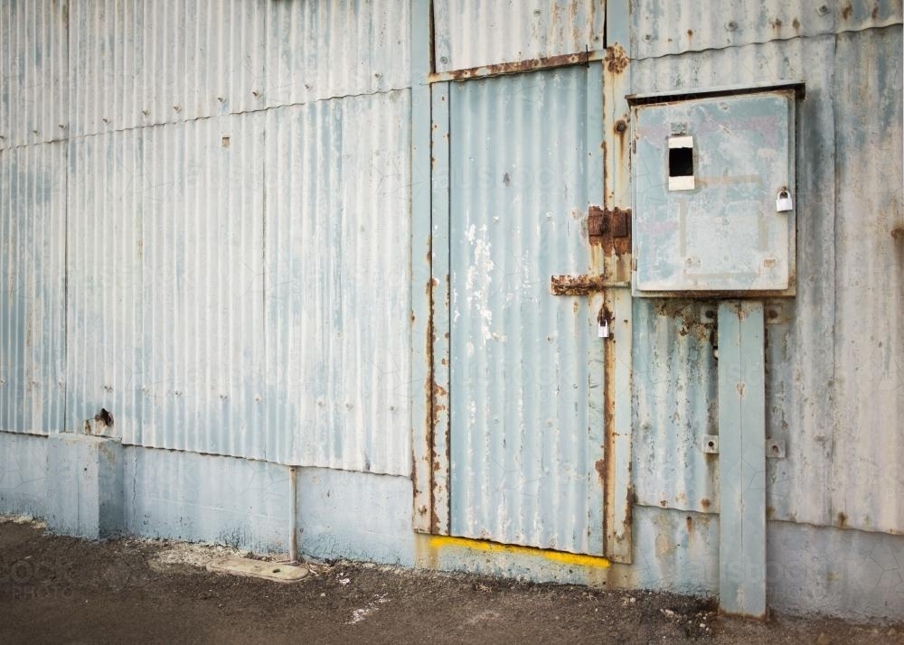 Old faded blue corrugated iron shed and door - Australian Stock Image