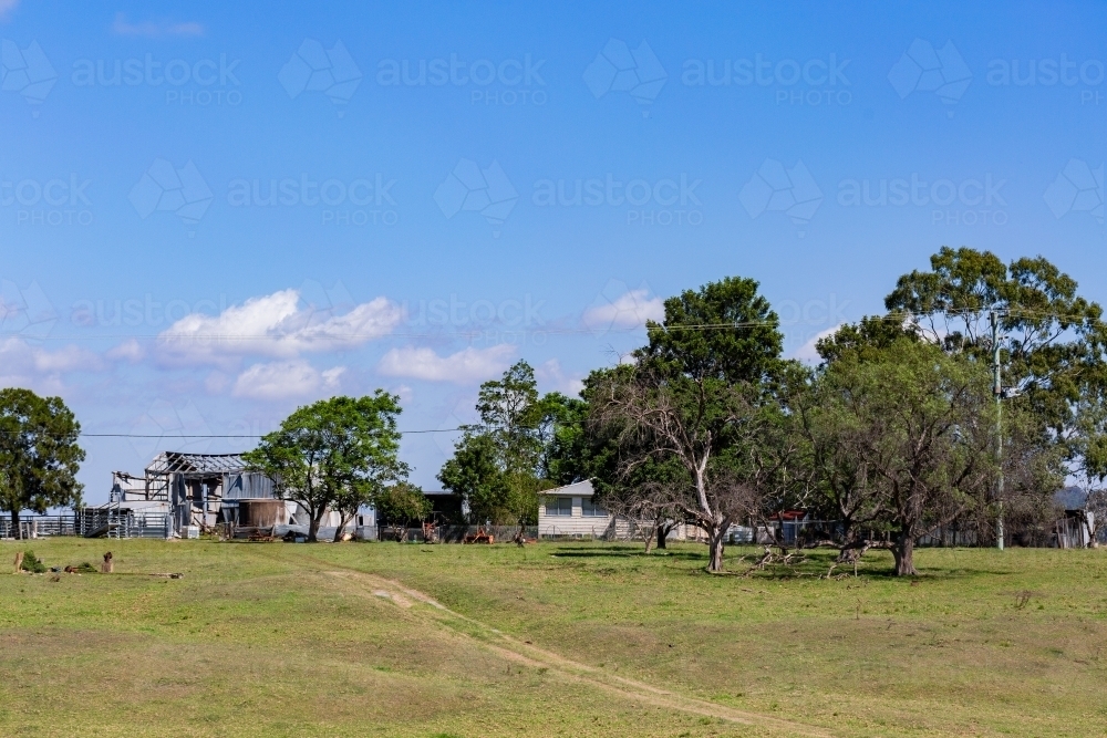 Image of Old farm building and farmhouse in paddock - Austockphoto