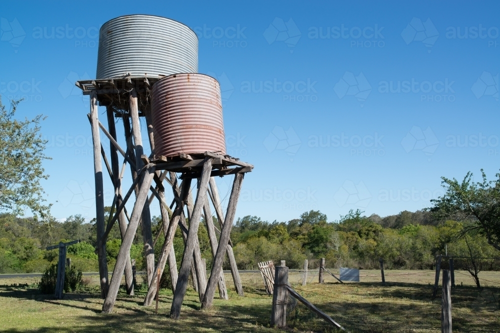 Old farm water tanks leaning - Australian Stock Image