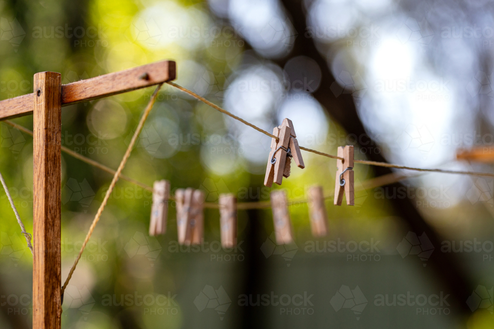 Old fashioned string clothes line with wooden pegs - Australian Stock Image