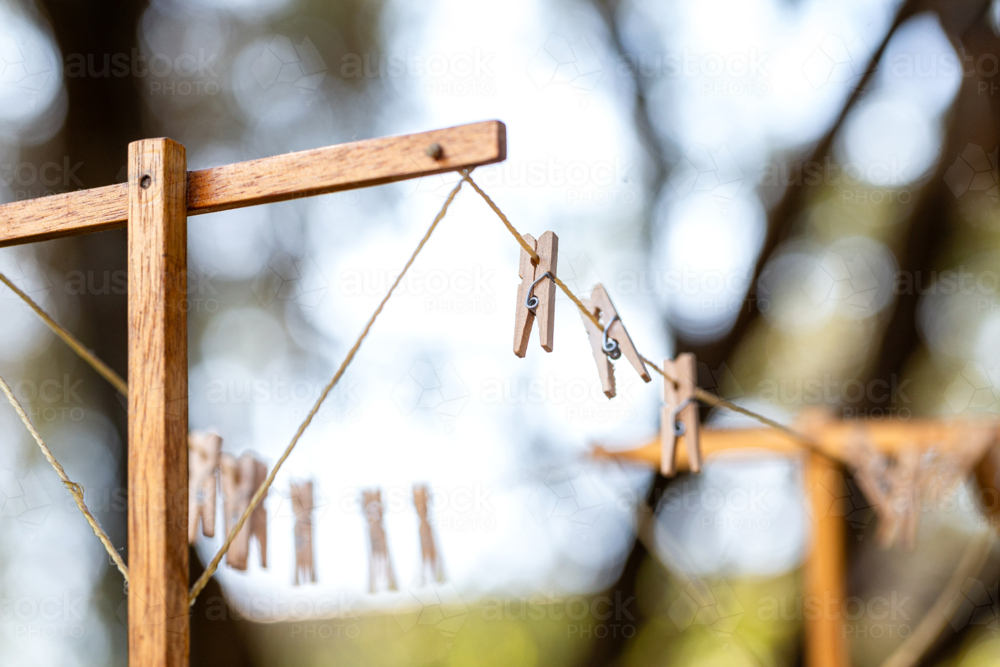 Old fashioned string clothes line with wooden pegs - Australian Stock Image