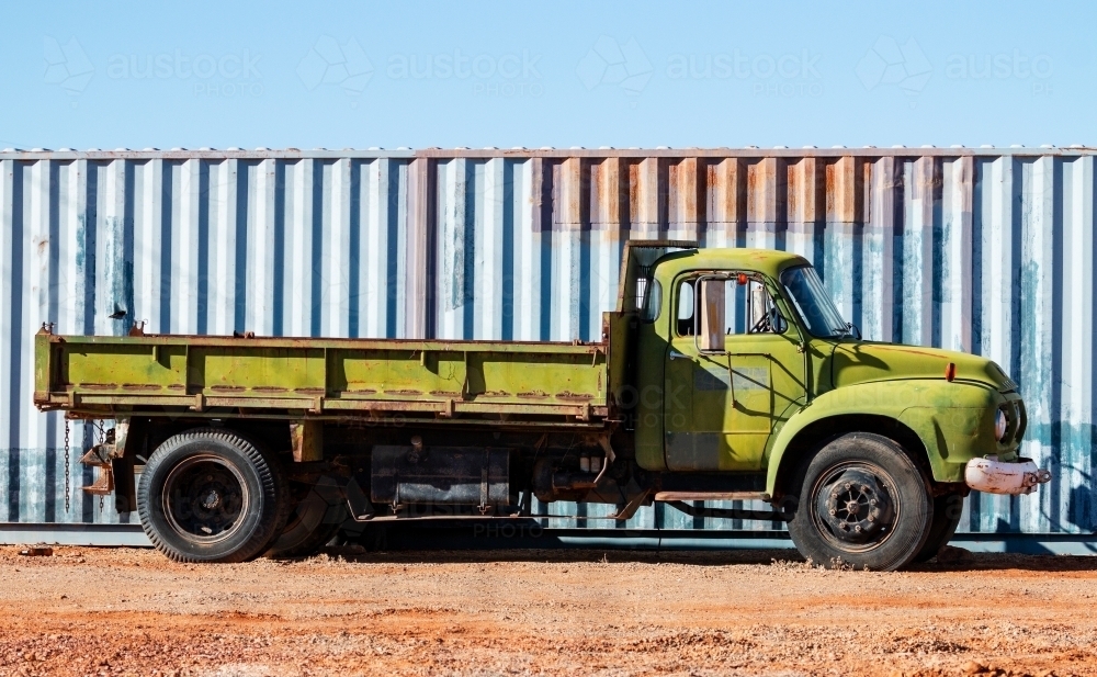 old green truck and blue shipping container - Australian Stock Image