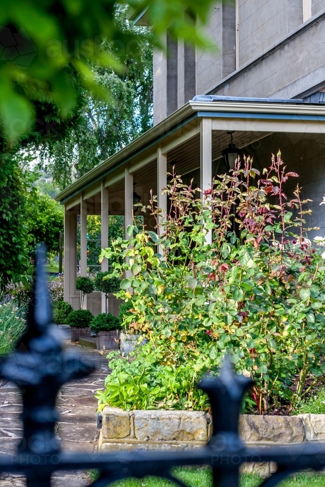Old house with path through lush green garden - Australian Stock Image