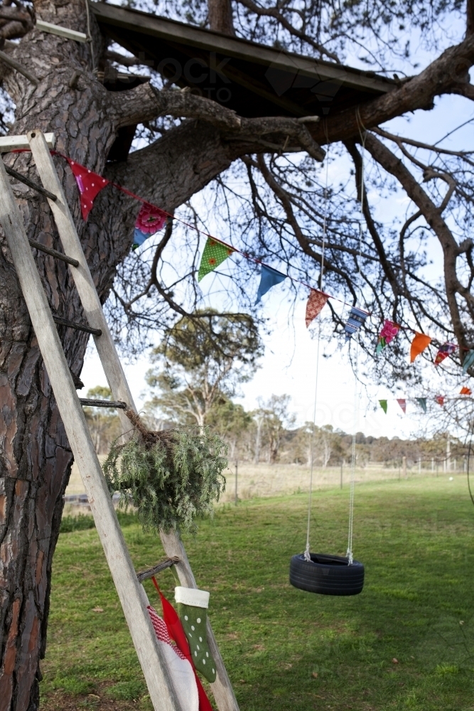 Old ladder with Christmas stockings and decorations in country backyard - Australian Stock Image