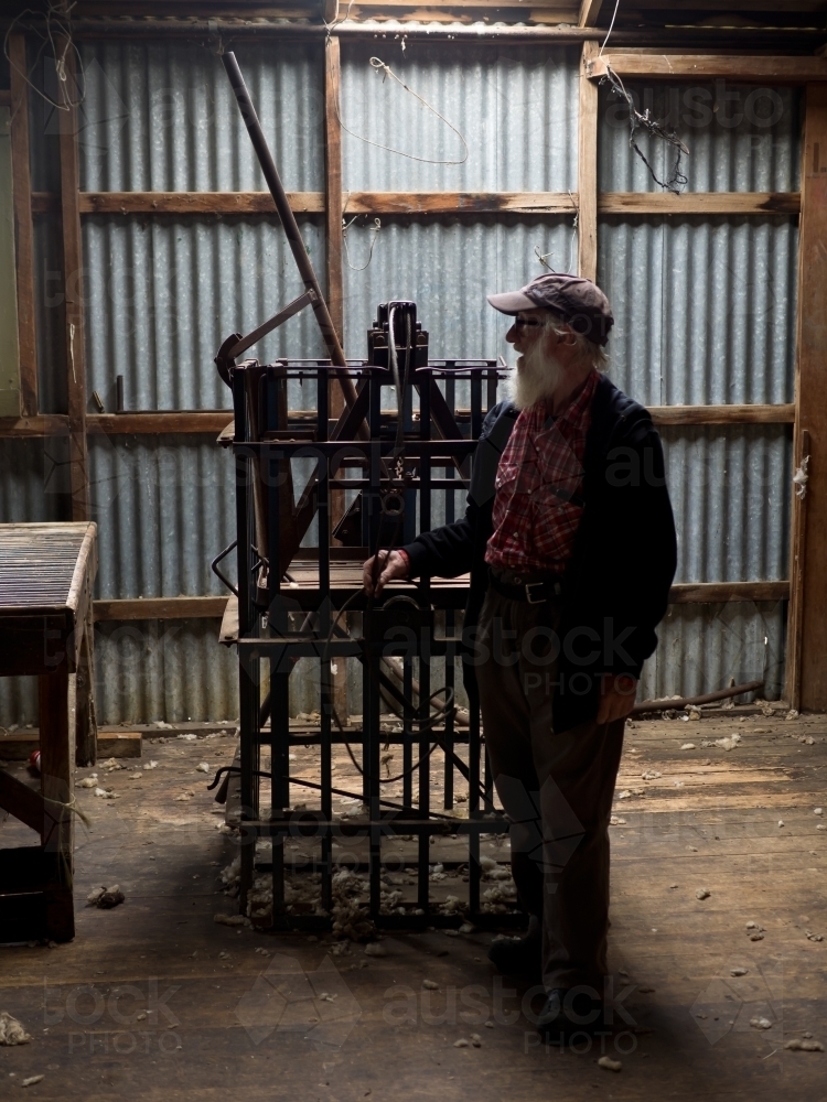 Old Man Contemplating in Shearing Shed - Australian Stock Image