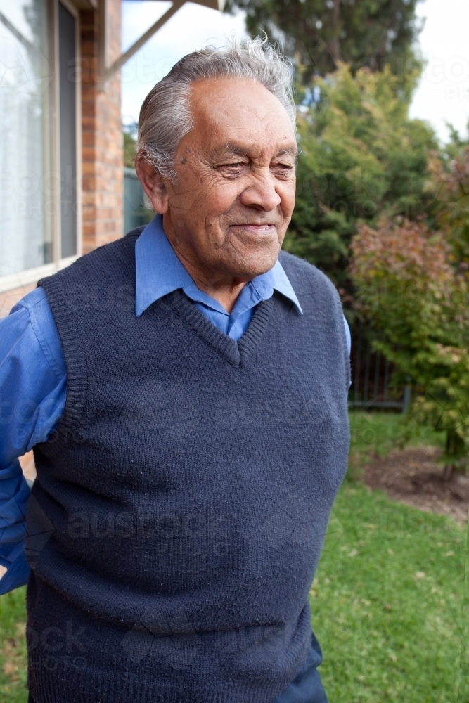 Old man standing in front of his home - Australian Stock Image
