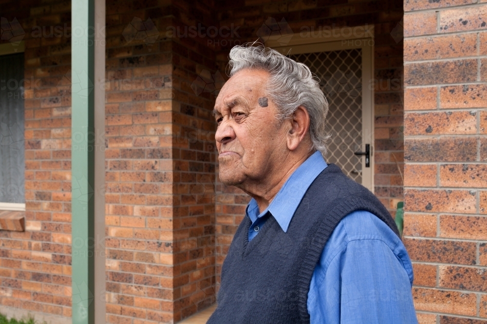 Old man standing outside his home - Australian Stock Image