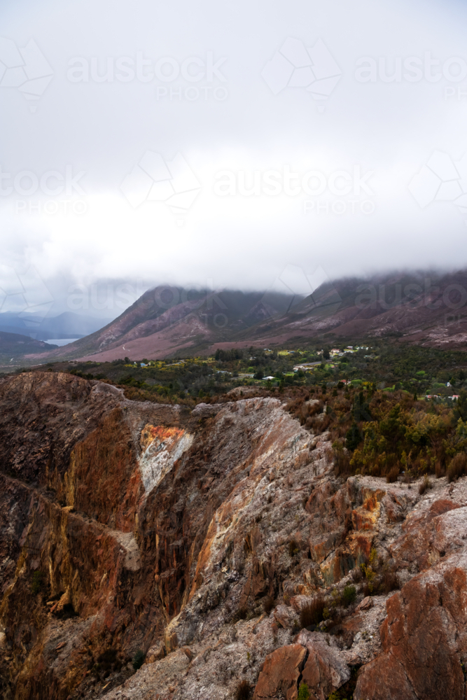old open cut mine in valley on a cloudy day, Tasmania - Australian Stock Image