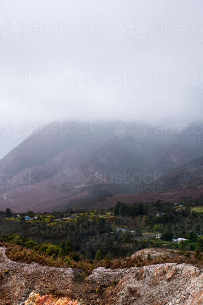 old open cut mine in valley on a cloudy day, Tasmania - Australian Stock Image