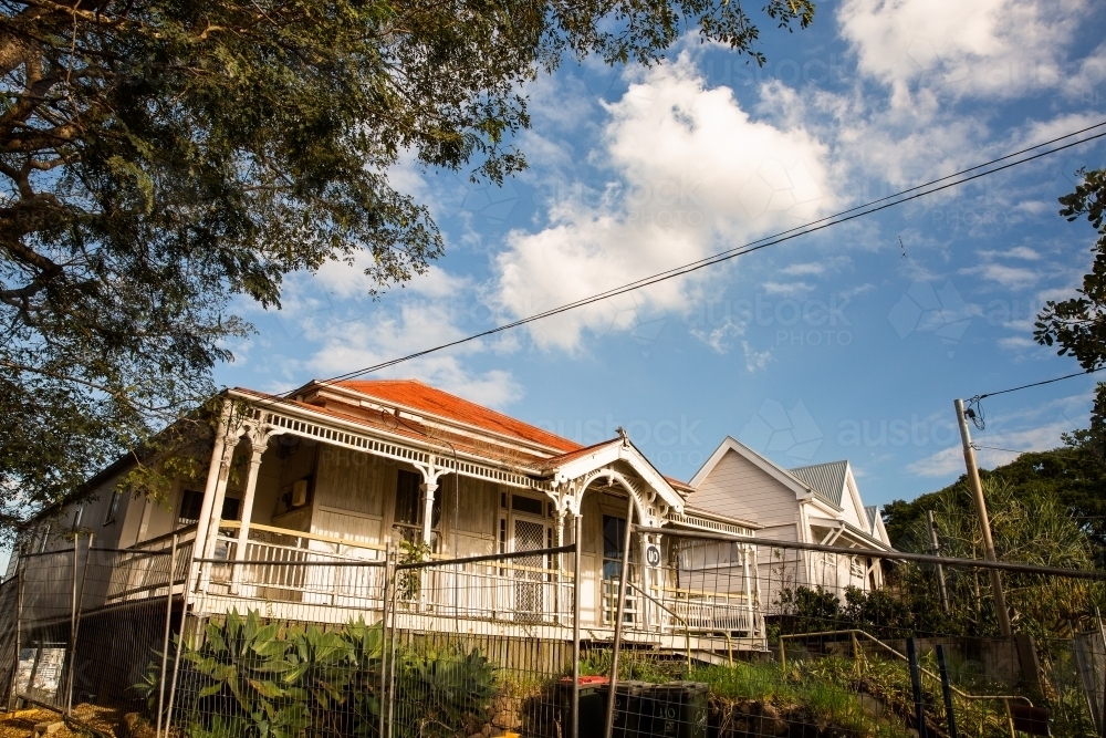 old Queenslander house behind a safety fence - Australian Stock Image