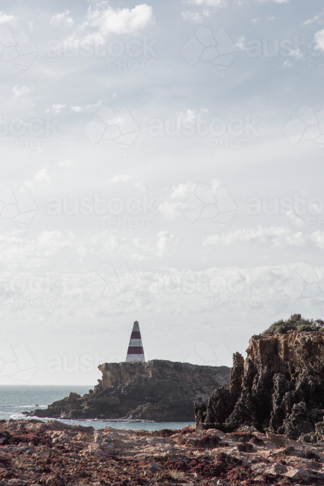 Old red an white striped obelisk (lighthouse) in Robe - Australian Stock Image