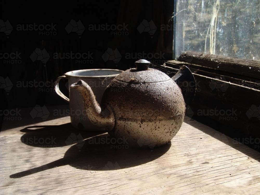 Old rustic teapot and enamel mug - Australian Stock Image