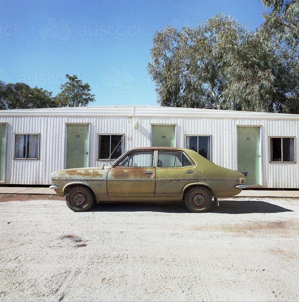 Old rusty car outside outback cabins - Australian Stock Image