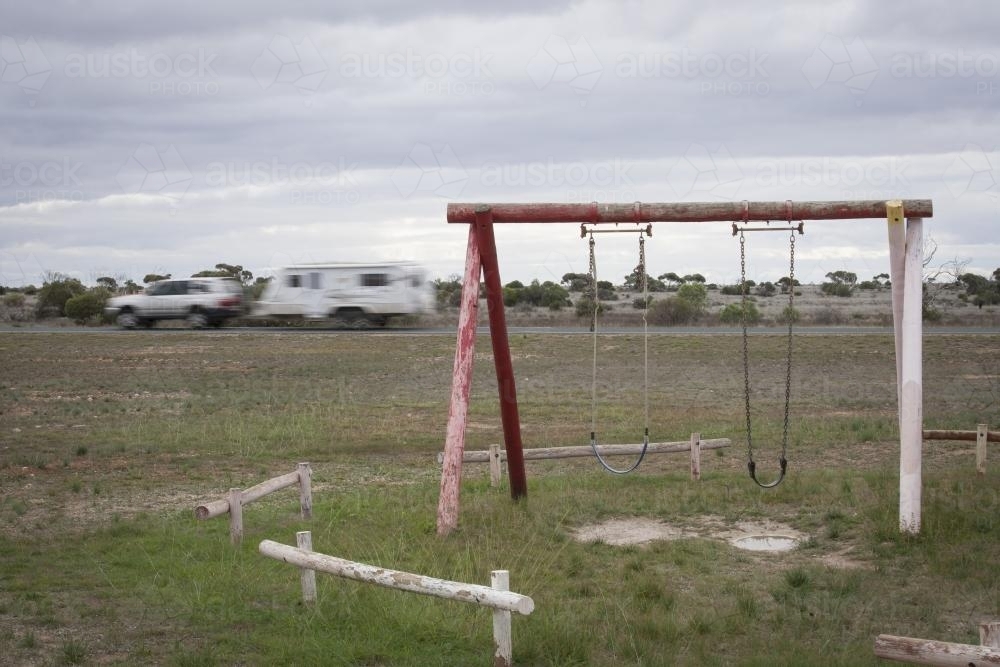 Old swings at a deserted playground on the Nullarbor - Australian Stock Image