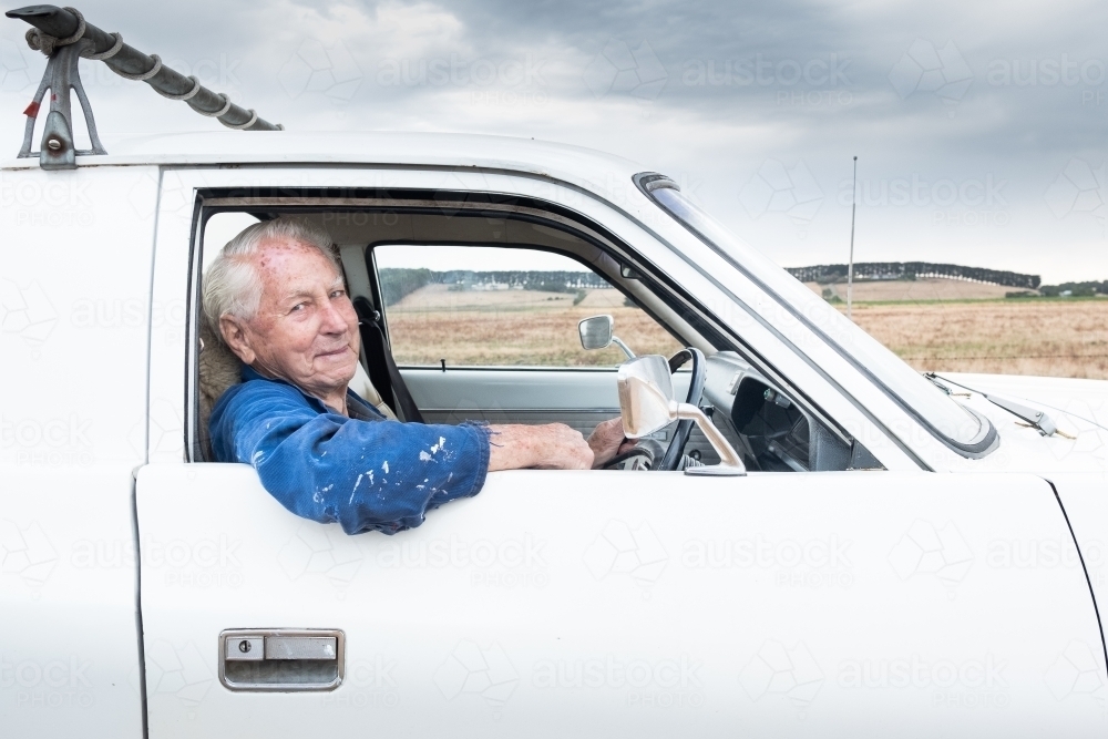 Old timer in his car looking out the window. - Australian Stock Image