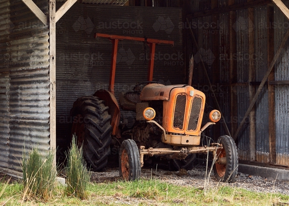 Old tractor in farm shed - Australian Stock Image