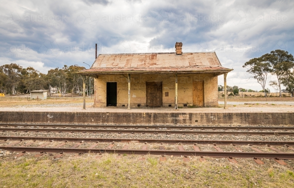 Old Train Station looking across the tracks to the platform and building - Australian Stock Image
