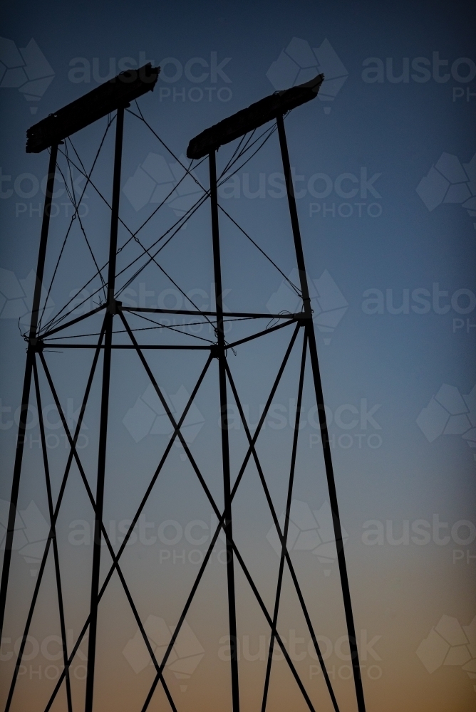 Old water tank stand at twilight - Australian Stock Image