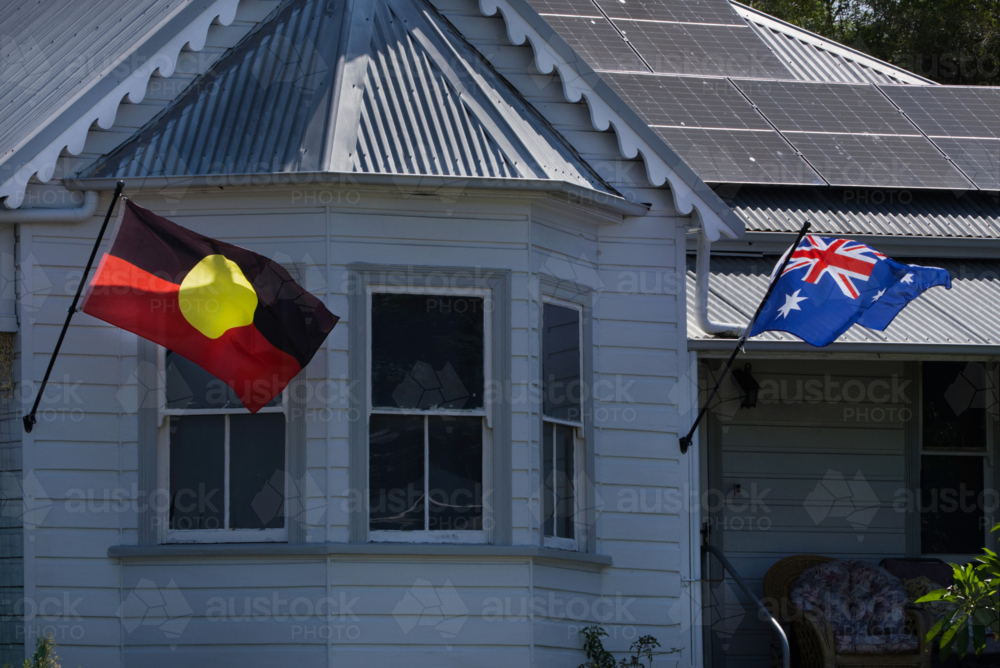 Old weatherboard home Aboriginal and Australian flags - Australian Stock Image
