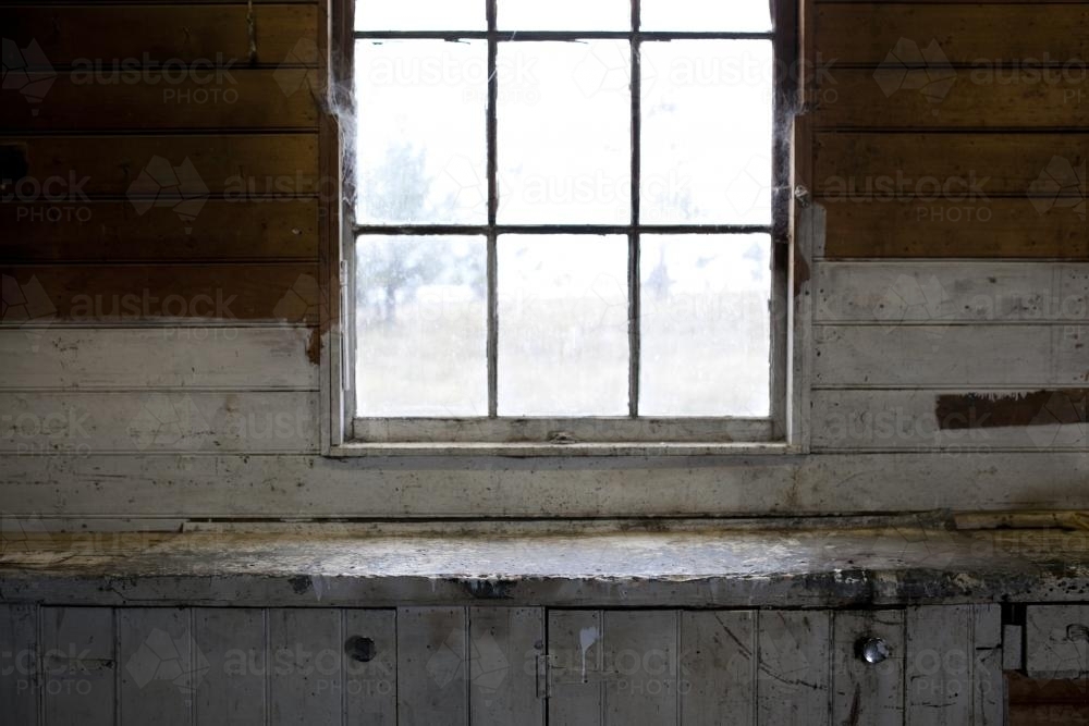 Old window with wooden cladding inside old shed - Australian Stock Image