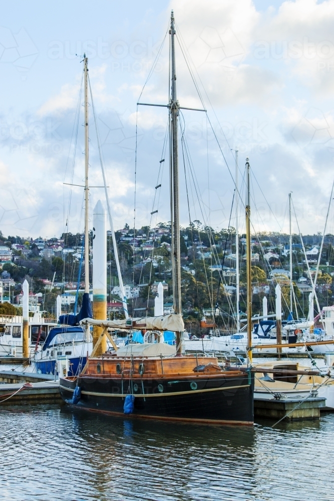 Old wooden boat moored in marina - Australian Stock Image