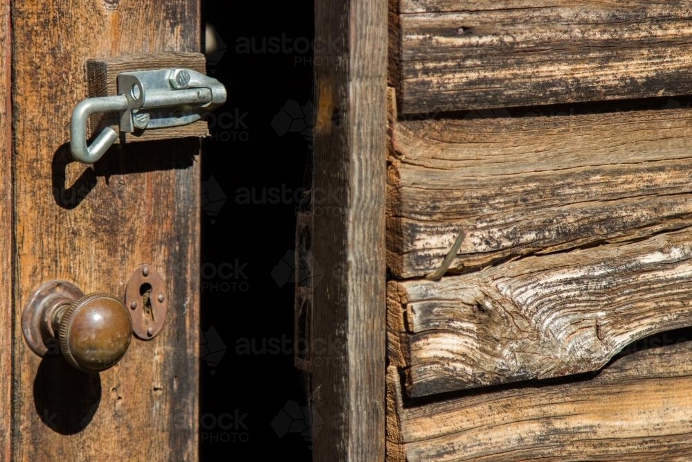 Old wooden door with a new bolt on it - Australian Stock Image