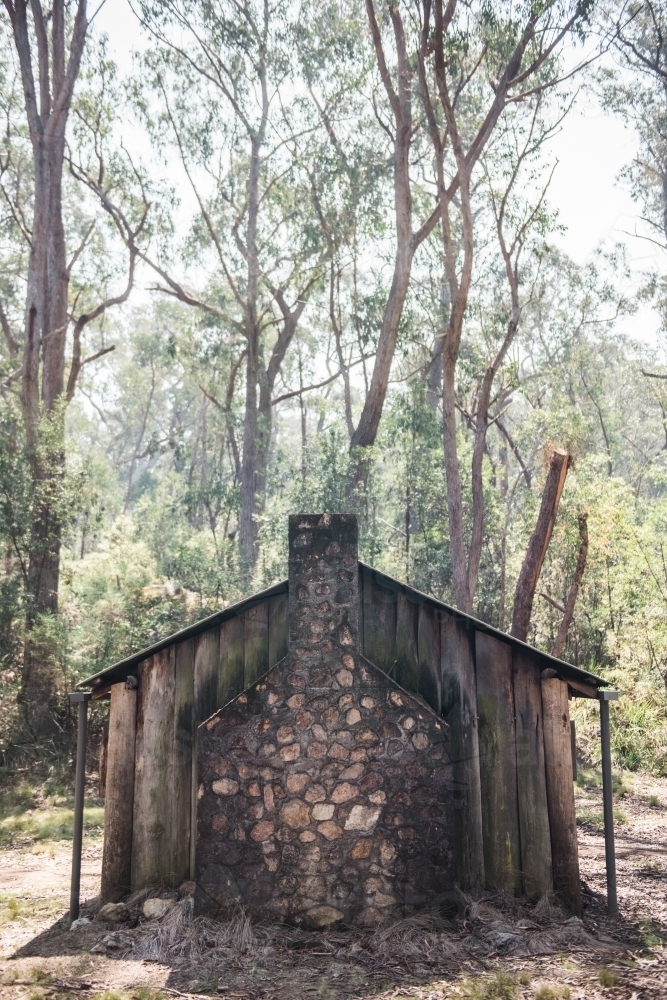 Old wooden shack with brick chimney in the bush - Australian Stock Image