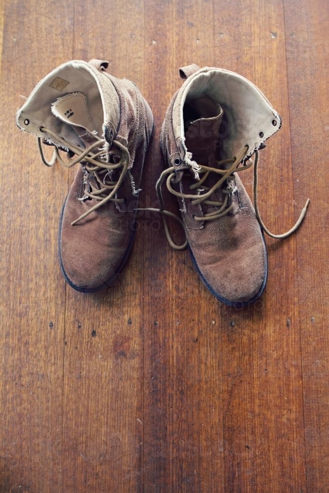 Old worn mens boots from overhead with copy space - Australian Stock Image