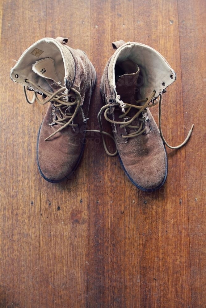 Old worn mens boots from overhead with copy space - Australian Stock Image